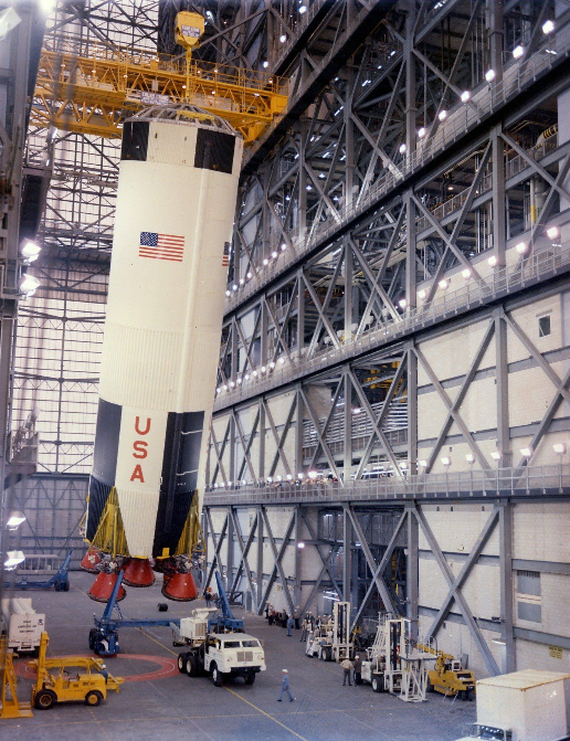 Teams lift the first stage of the Apollo 8 Saturn V rocket inside the transfer aisle of the Vehicle Assembly Building at NASAâ€™s Kennedy Space Center in Florida on Feb. 1, 1968, and prepare to place it atop the mobile launcher. Apollo 8 was the first crewed spacecraft to successfully orbit the Moon and return to Earth, setting the stage for Apollo 11 â€“ the first crewed lunar landing. Apollo 8 launched on Dec. 21, 1968, and the crew members consisted of Frank Borman, William A. Anders, and James A. Lovell Jr.