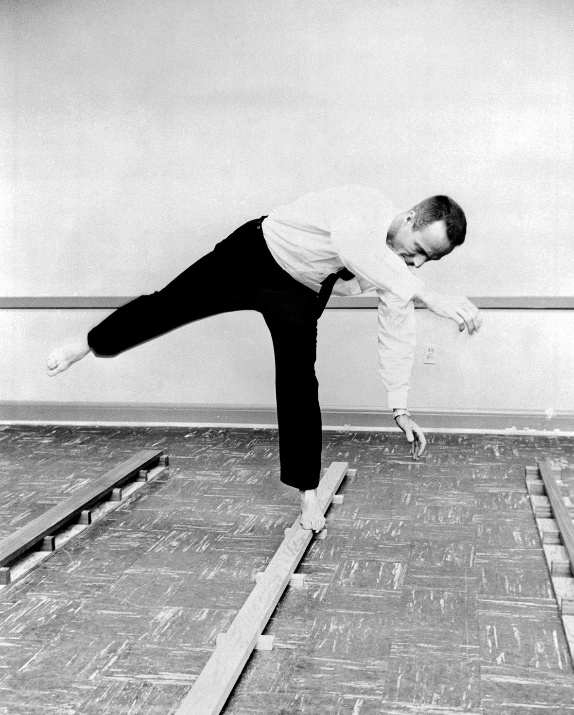 Barefoot on a thin wooden beam, Carpenter's balance is evaluated prior to his mission
