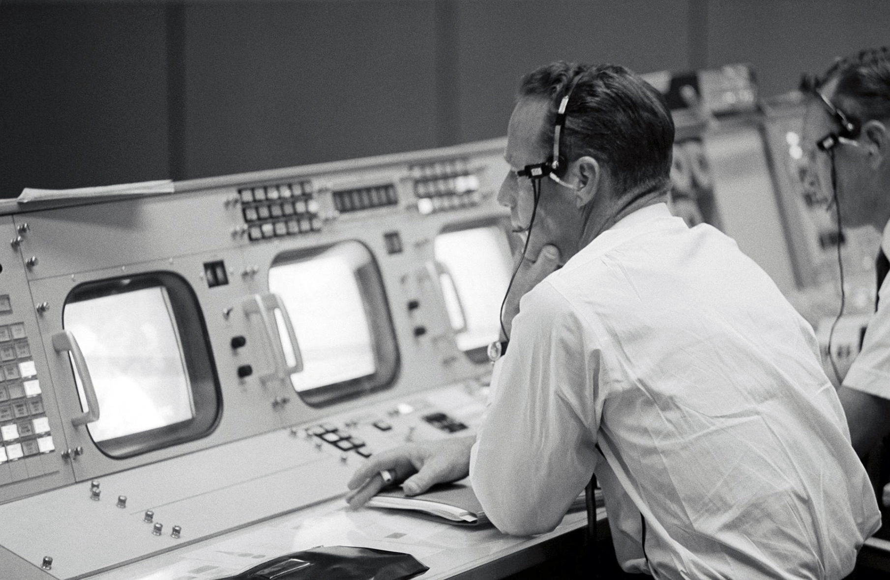 Carpenter watches the monitor at his console in Mission Control during the launch of Gemini 11 in 1966