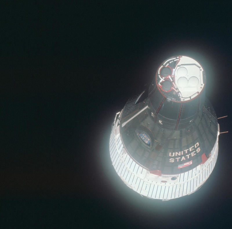 Nose-on image of the Gemini 6 spacecraft against the blackness of space, taken from Gemini 7