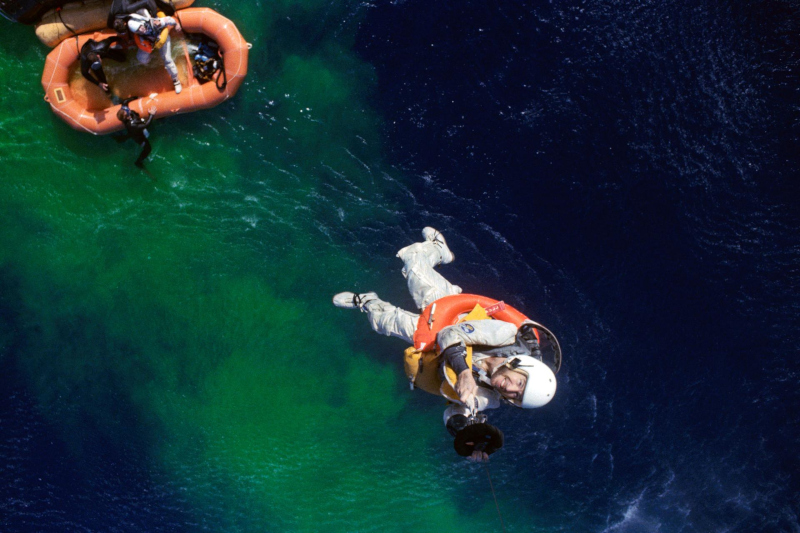 Looking down from the recovery helicopter as astronaut lovell is winched aboard following splashdown