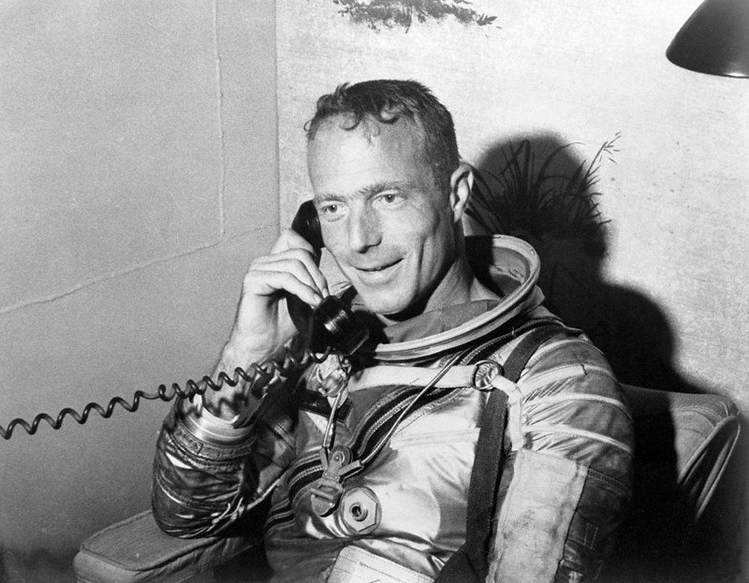 Sitting aboard the recovery ship, Carpenter takes a radio telephone call from President Kennedy