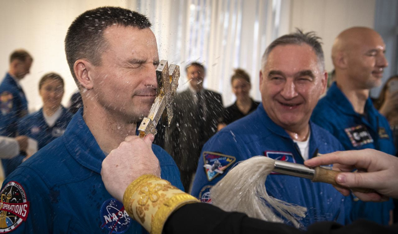 Morgan closes his eyes as he receives a blessing from the Russian Orthodox church at Baikonur on his back-up assignment for ISS Expedition 59