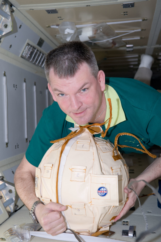 Samokutyaev poses for the camera while working with equipment in the MRM1 module aboard the ISS