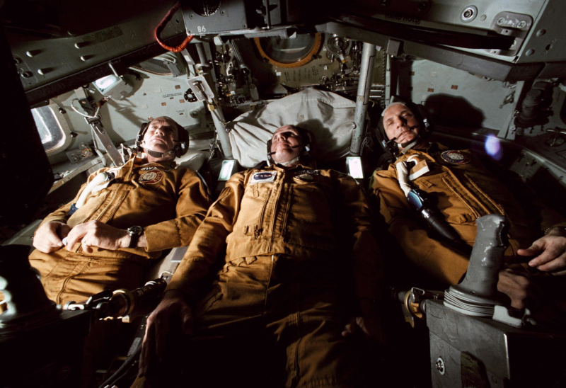 The American Apollo-Soyuz astronauts lying in their seats during a simulation exercise
