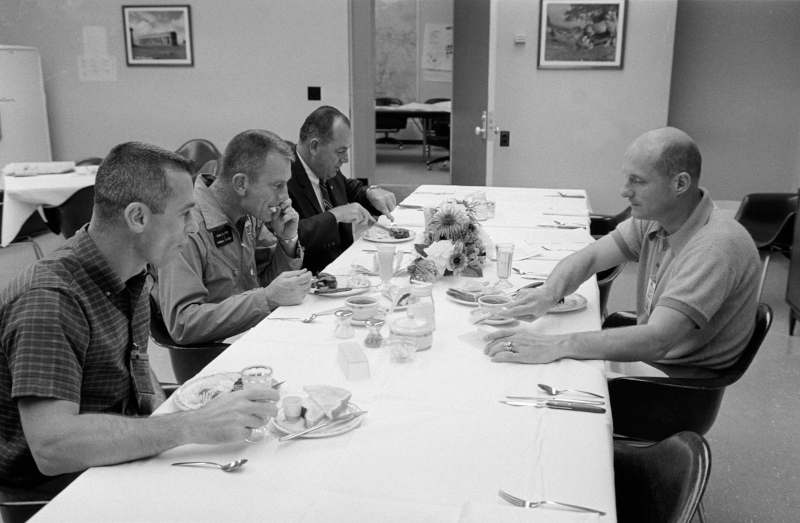 black and white image of the Gemini 9 crew taking breakfast on launch day